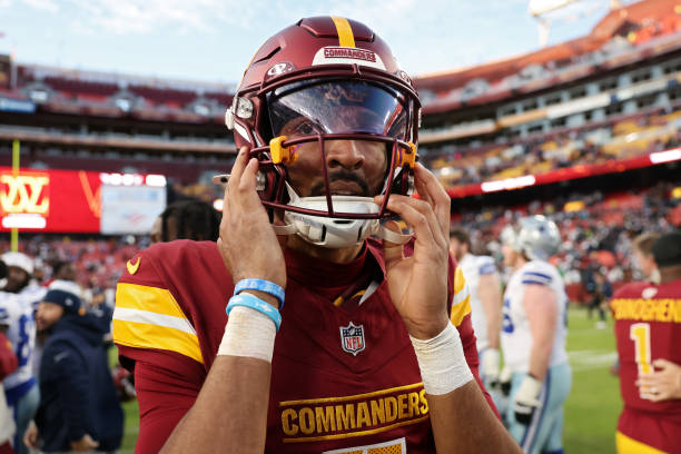 Jayden Daniels #5 of the Washington Commanders looks on after losing to the Dallas Cowboys 34-26 at North