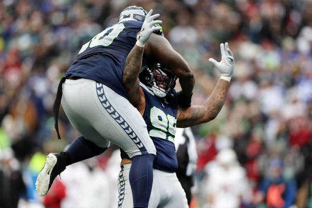 Leonard Williams #99  reacts with Jarran Reed #90 of the Seattle Seahawks after a sack 