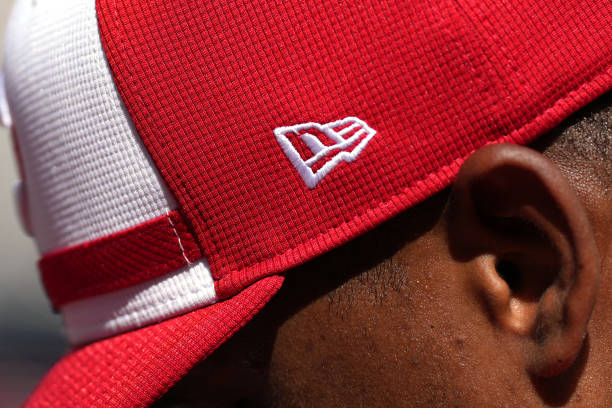 : Detailed look at the New Era logo on the side of the hat of Jeimer Candelario #3 of the Cincinnati Reds during batting practice before the game against the San