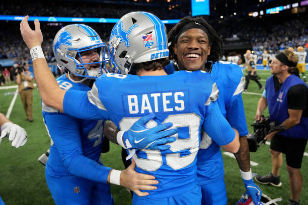 Jake Bates #39 of the Detroit Lions celebrates with Hogan Hatten