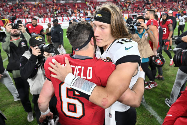   Trevor Lawrence #16 of the Jacksonville Jaguars and Baker Mayfield #6 of the Tampa Bay Buccaneers meet on the field 