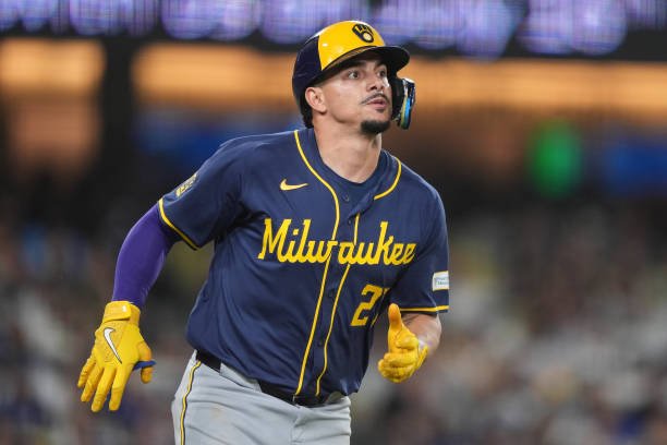 Willy Adames #27 of the Milwaukee Brewers runs to first base against the Los Angeles Dodgers